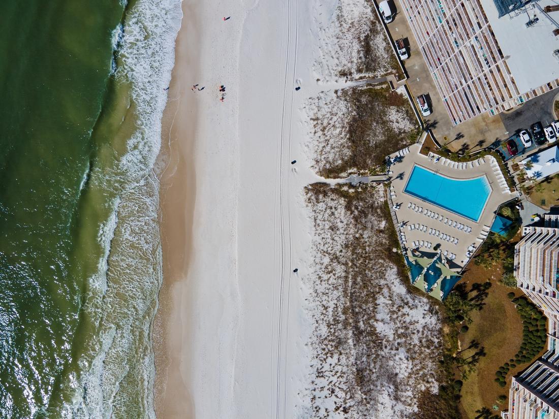 Top-down aerial of the beach and pool