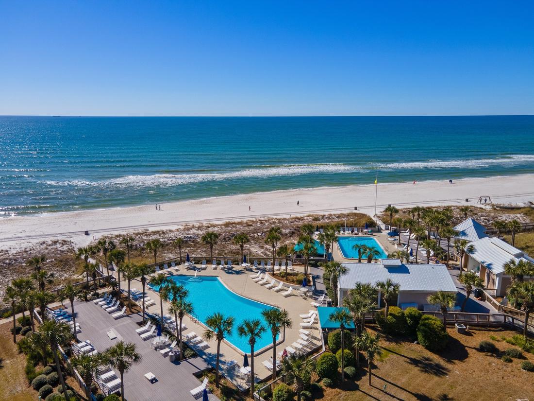 Pool deck and white-sand beach from above