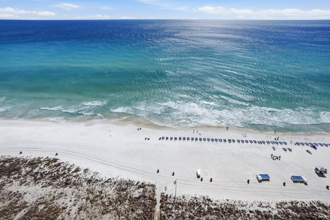 White-sand beach and umbrellas from above