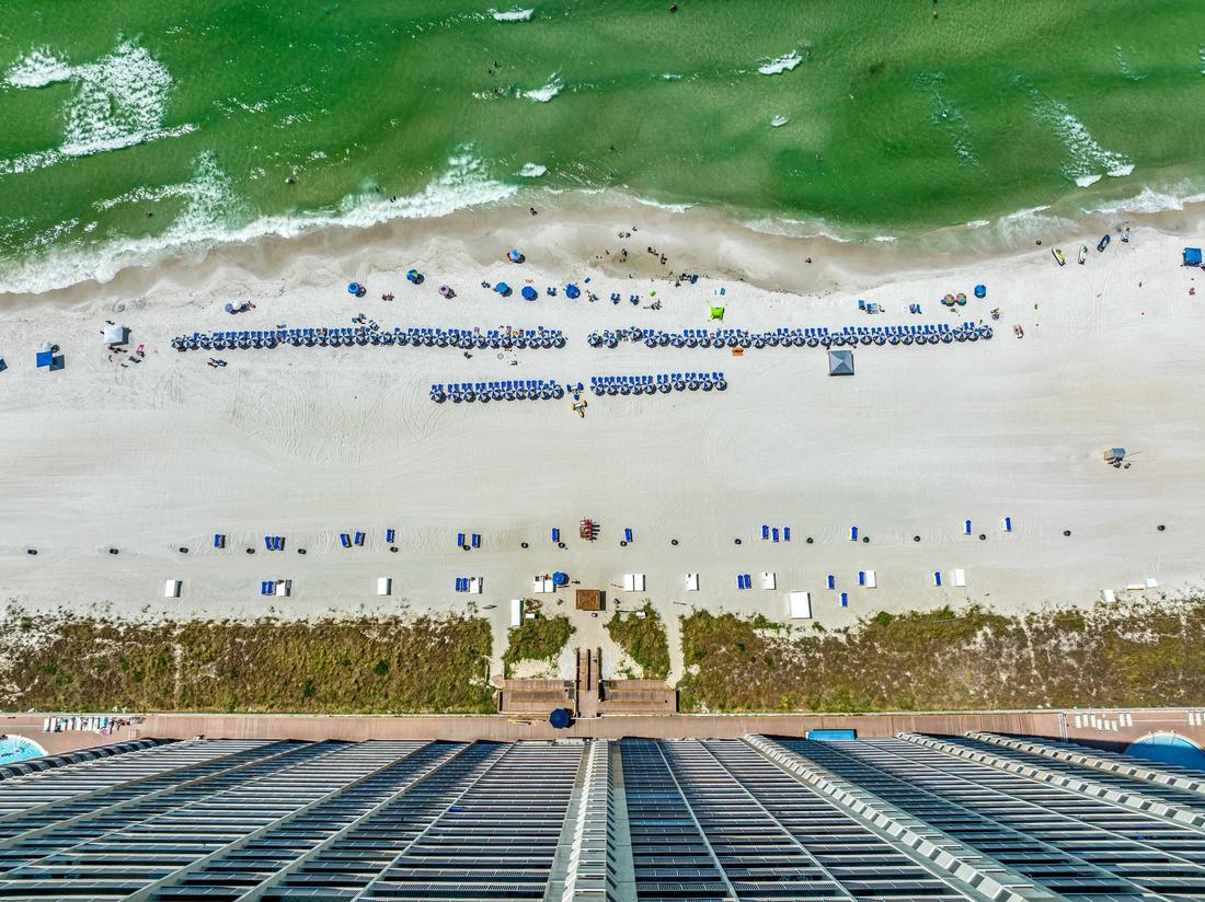 Top-down view of beach chairs on the sand