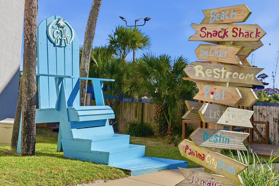 Beach signpost and oversized beach chair