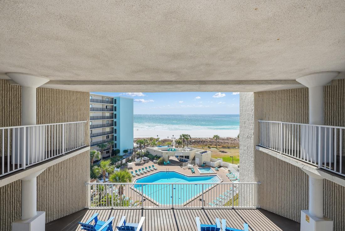 Pool and beach seen from a breezeway