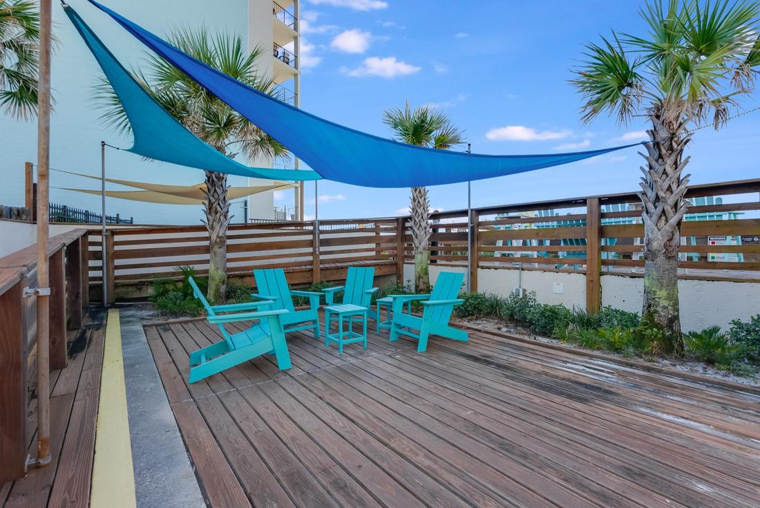 Shaded deck with Adirondack chairs